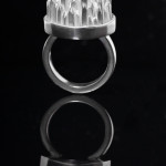 A sterling silver ring with square stock spikes and square stock shank.