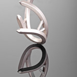 a sterling silver ring with square stock spikes in an open formation is photographed on a grey mirrored background.