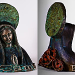 A bronze bust of the Virgin Mary with an aztec calendar as a halo, roses on her back, and an El Camino emblem on her chest is seen on a white background.