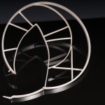 A gothic rose window inspired sterling silver bracelet is shown on a mirrored black background.