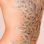 The metal lace corset from Something New is seen worn on the body with a cream background.